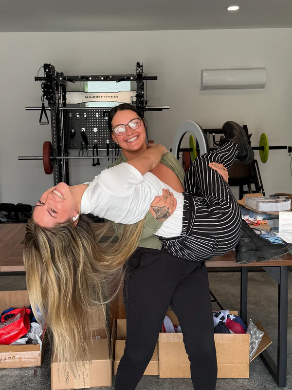 Two OpenbooQ team members embracing