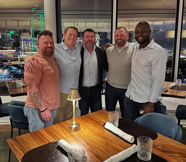 OpenbooQ founders at a rooftop restaurant